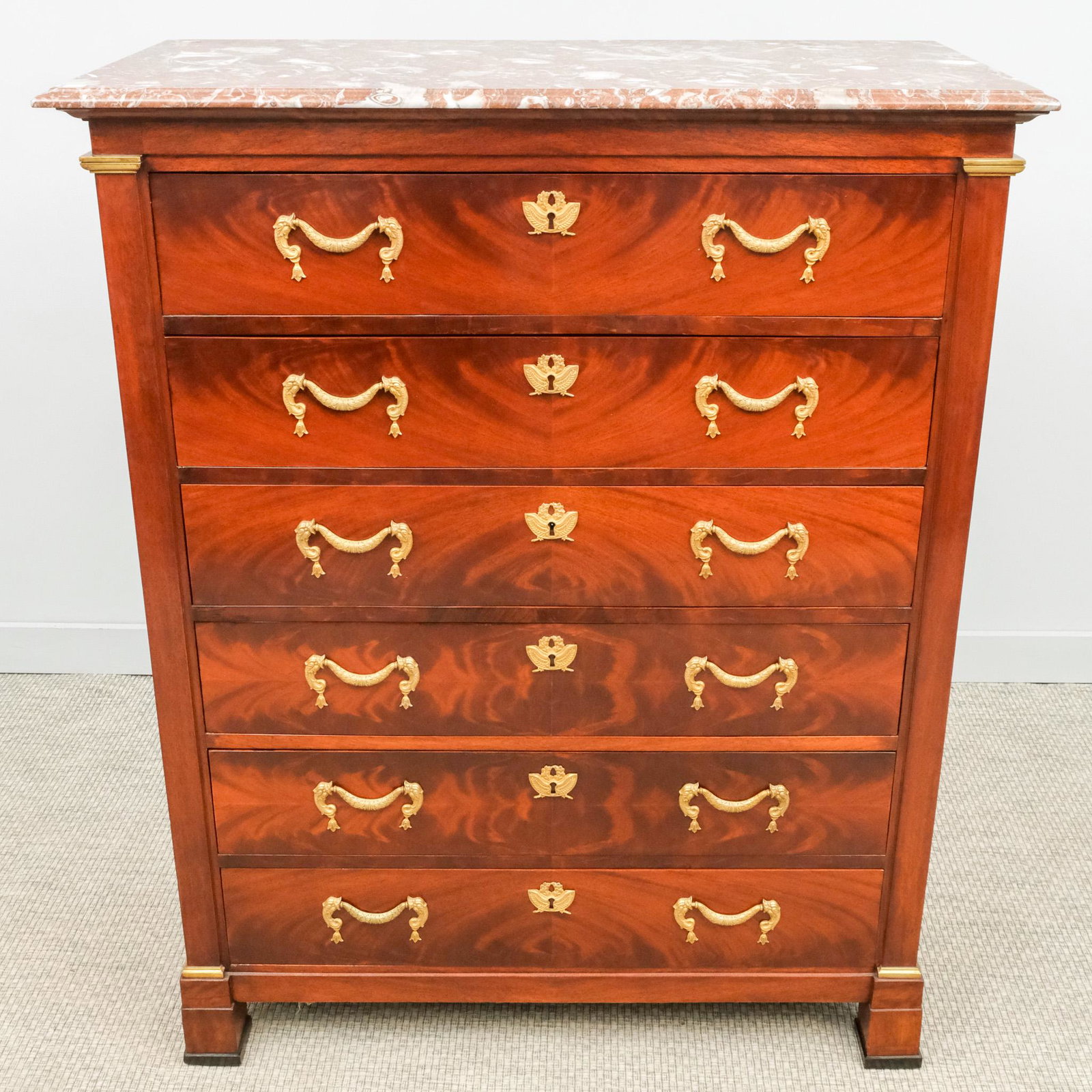 Louis Philippe Mahogany Dresser: 19th century Louis Philippe mahogany dresser with gilt drawer pulls, red marble top, 53" H x 42" W x 19 1/2" L.