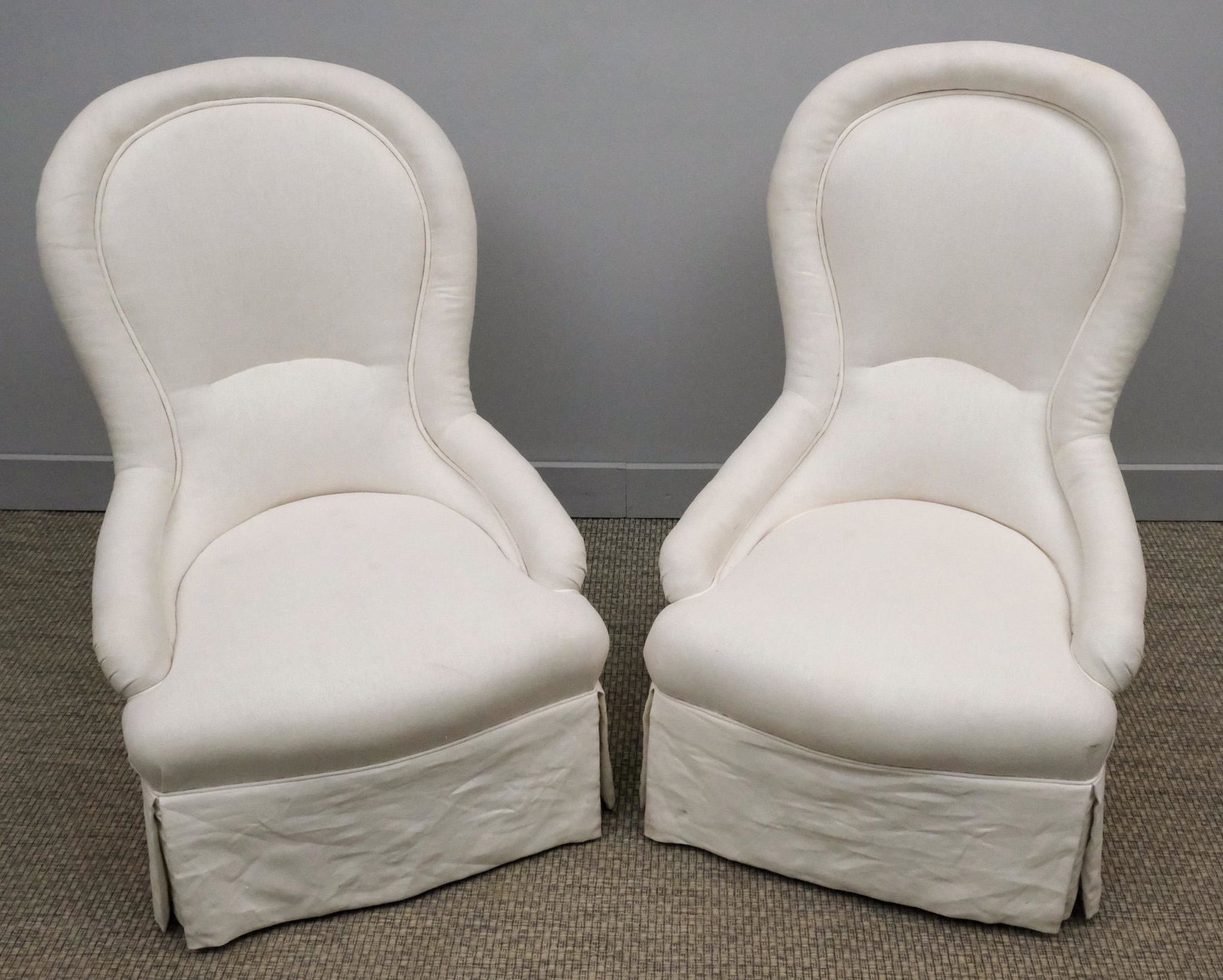 Pair of White Slipper Chairs: Pair of French 19th century slipper chairs with balloon backs and later upholstery, 38" H x 25" W x 24" L.