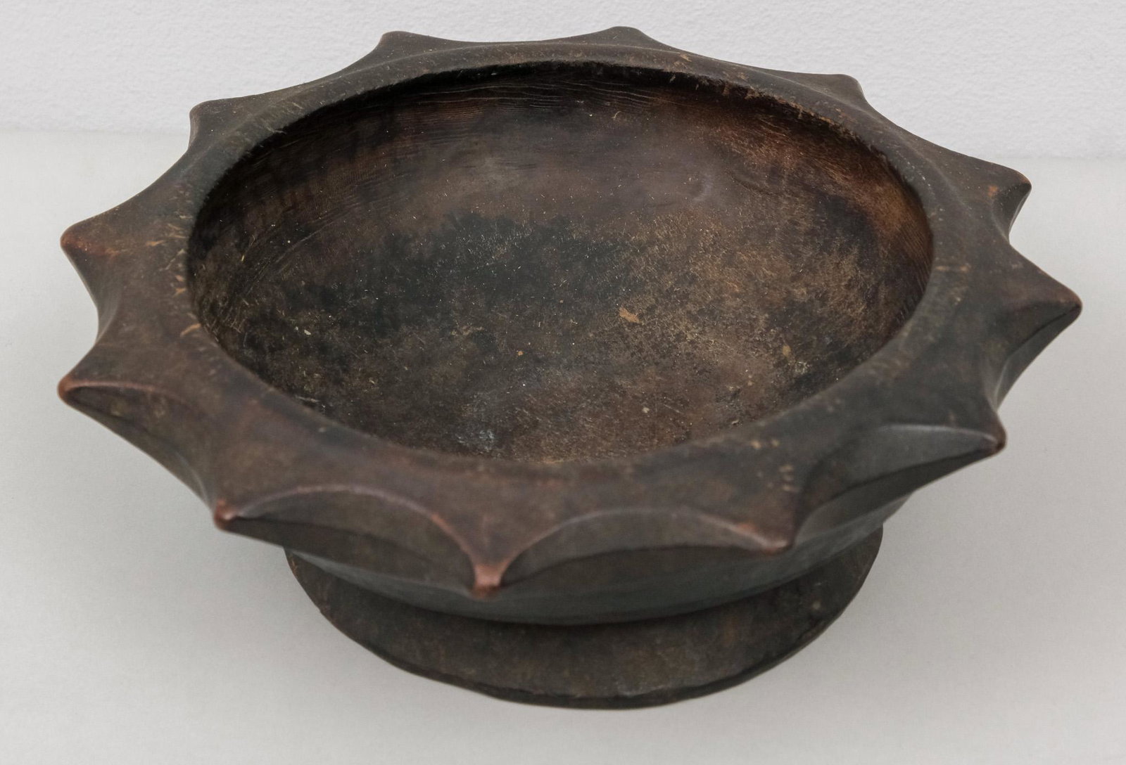 Antique Primitive Carved Wooden Bowl: With spiked rim and dark stained body. 9 1/4" diameter.