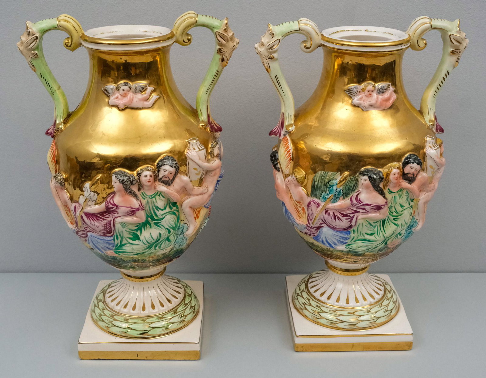 Pair of Capodimonte Style Vases: Festooned with neoclassical figures. 14" tall.