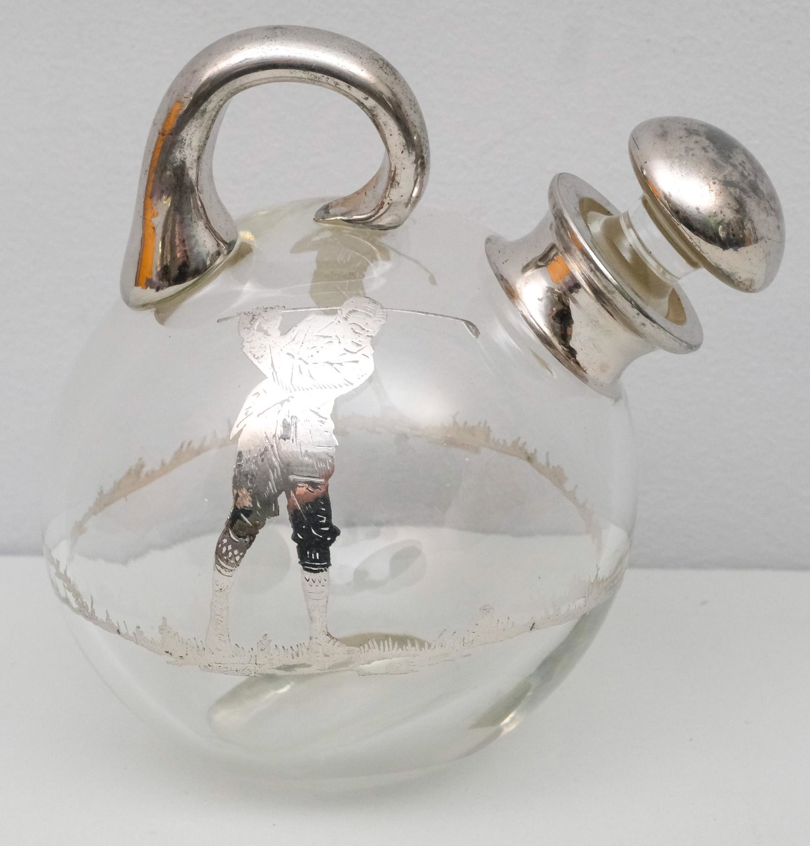 Sterling Silver Overlay Leaning Golf Decanter: Leaning globular form with double sided decoration. Hallmarked as shown. 6 1/4" tall.