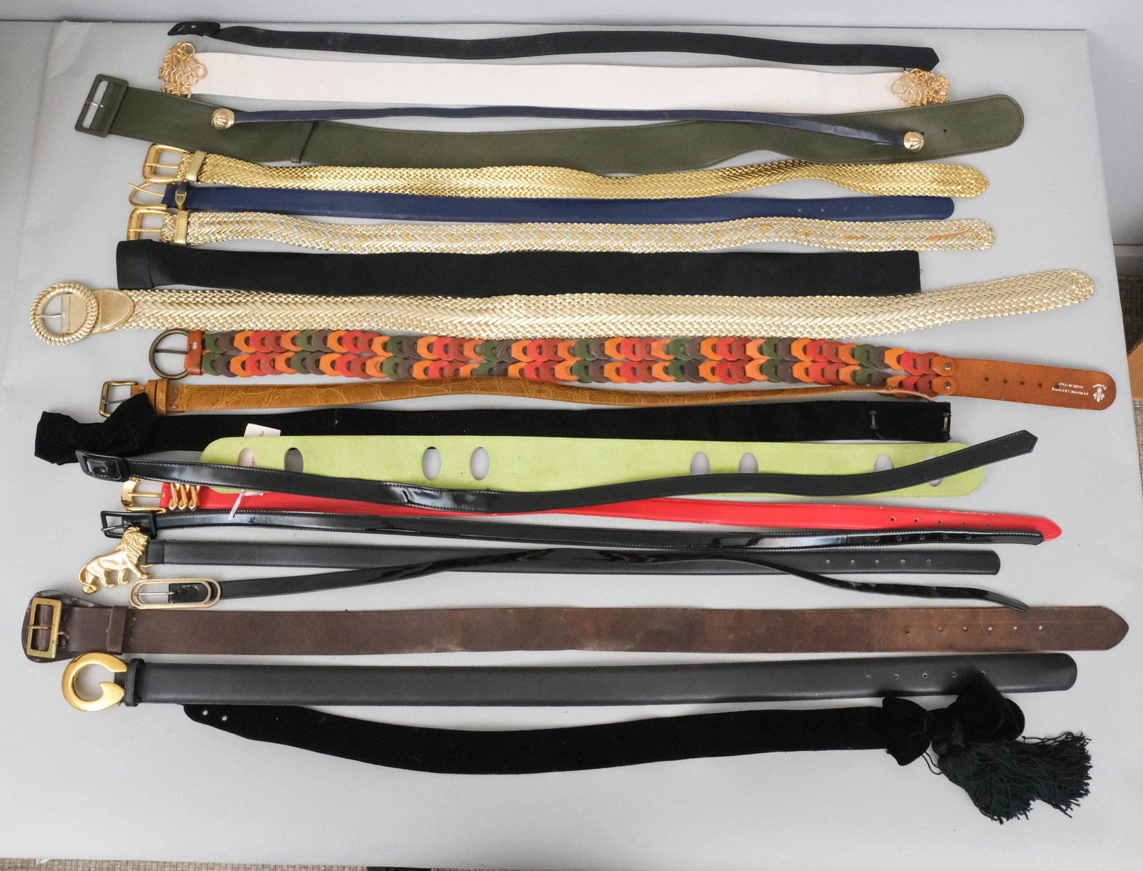 Large Group of Women's Belts: Brands include Firenze, Jones New York, Piazza Sempione, Gail La Belle, sizes seem to be M/L and in the 10 to 12 range, fabrics include suede, leather, velvet, satin and more. Refer to photos for more