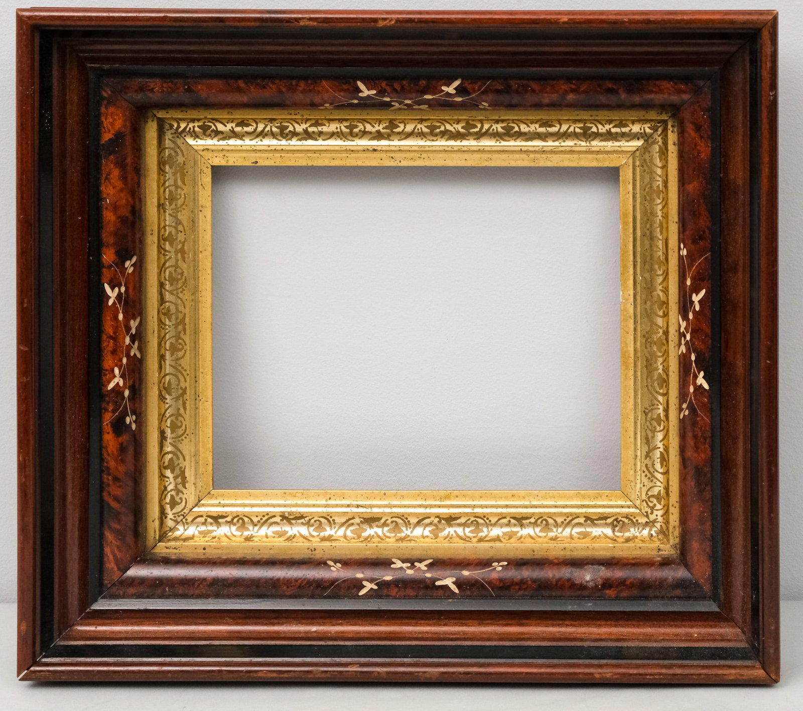 Aesthetic Movement Eastlake Frame 8" x 10": American, circa 1870, having alternating levels of burl, ebonizing, incising, and stenciling in a great standard size, with lemon gold liner. Rabbet 8" x 10", Overall 15" x 17", Molding 4".