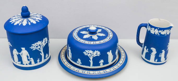 Group of Antique Wedgwood Jasperware: Comprising a syrup pitcher (lacking lid), a cheese dome (interior staining), and a biscuit jar. Marked as shown. Biscuit 7 3/4".