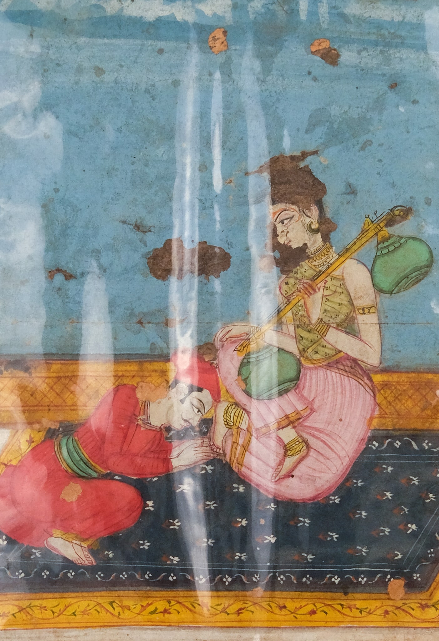 Deccan School, Man at Woman's Feet: Deccan, Golconda, 18th century gouache on paper depicting a man curled up at a woman's feet, 6 1/4" x 4 1/4" sight size, 14 1/2" x 9 1/2" mat size.