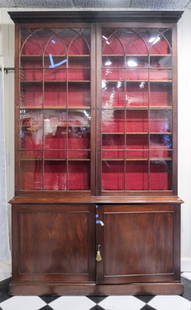 Antique George III Bookcase Cabinet: 19th century English George III mahogany bookcase and cabinet with glazed Gothic arched doors over two solid paneled doors in base, 108 1/2" x 66" x 15 1/2".