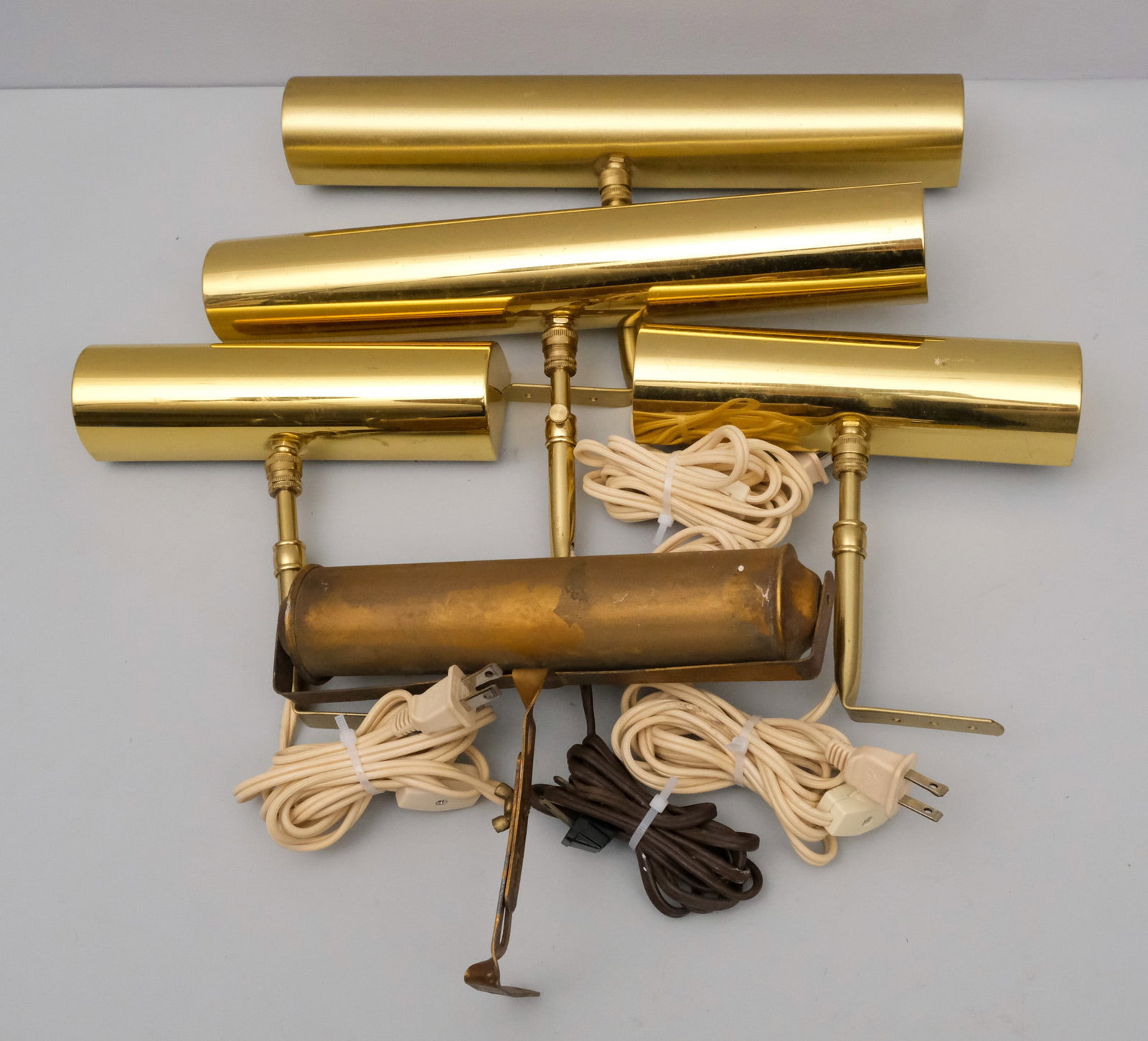 Group of House of Troy Gallery Lights: In brass finish. Together with one as is example by another maker. Largest 14".