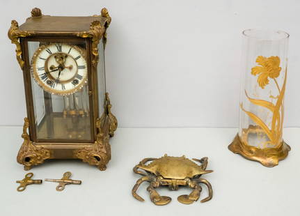 Group of Antique Brass Table Objects: Comprising a brass mounted glass vase with over enamel decoration, a figural crab box, and a mantle clock.
