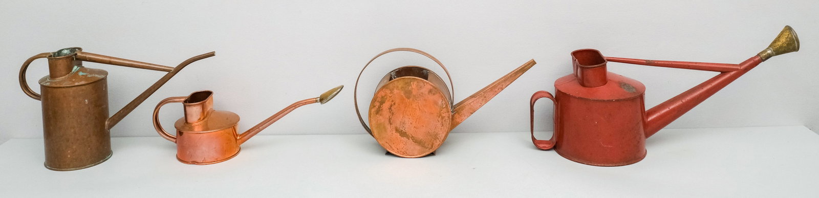 Group of Antique Watering Cans: Comprising 3 from Haws of England together with a Bauhaus type. Largest 18".