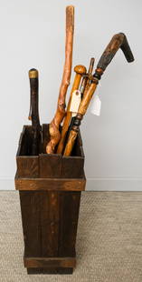 Canes & Mission Oak Cane Stand: Lot of various canes, including bamboo walking stick, knob cane, twisted bark cane, and carved folk art cane, largest cane 43 1/4", smallest cane 34 1/2", and mission oak cane or umbrella stand, 29 1/