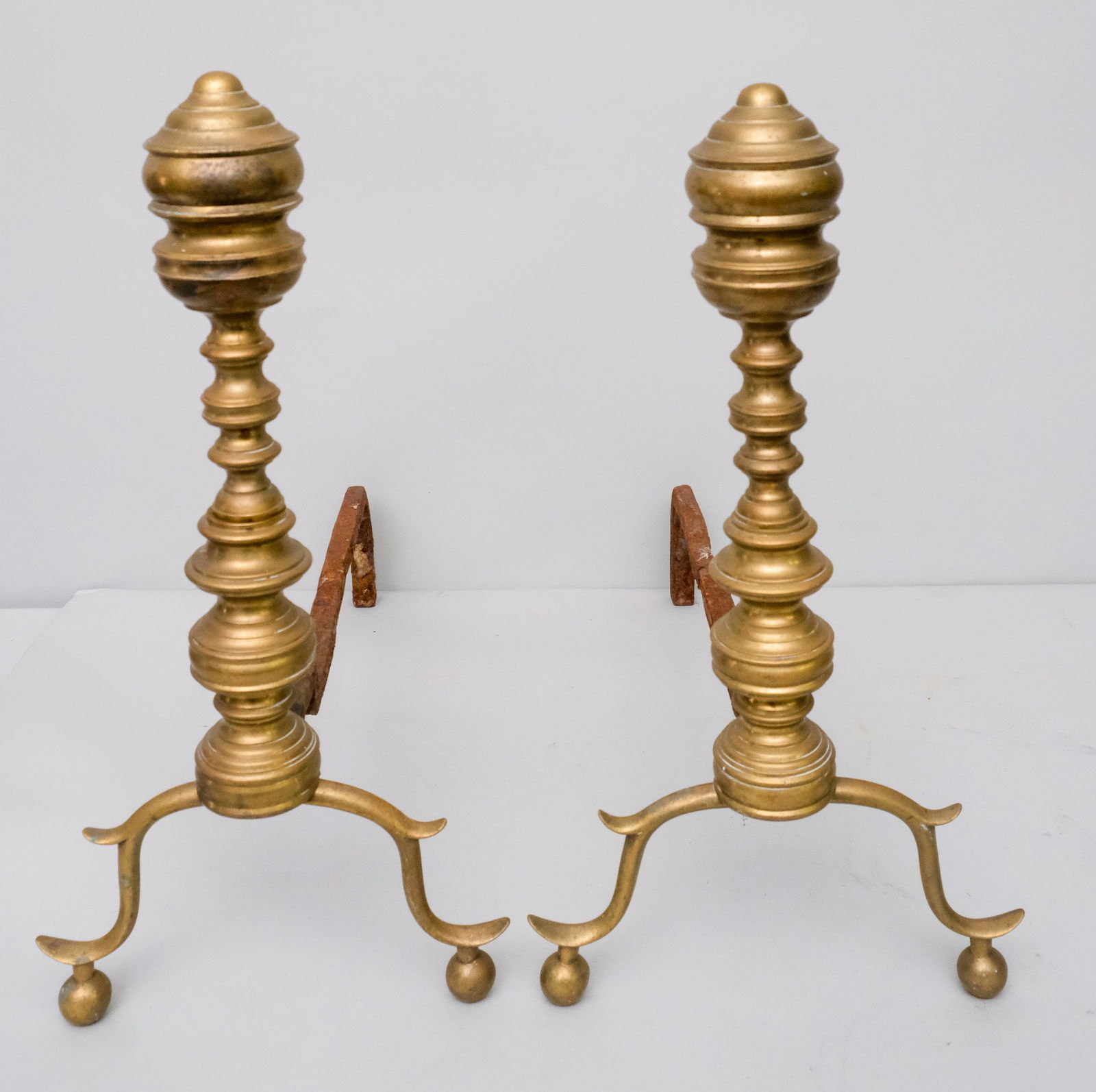 Pair of Empire Cast Brass Andirons: Pair of 19th century Empire cast brass andirons, ring-turned with balustrade top, 17" x 9" x 19".