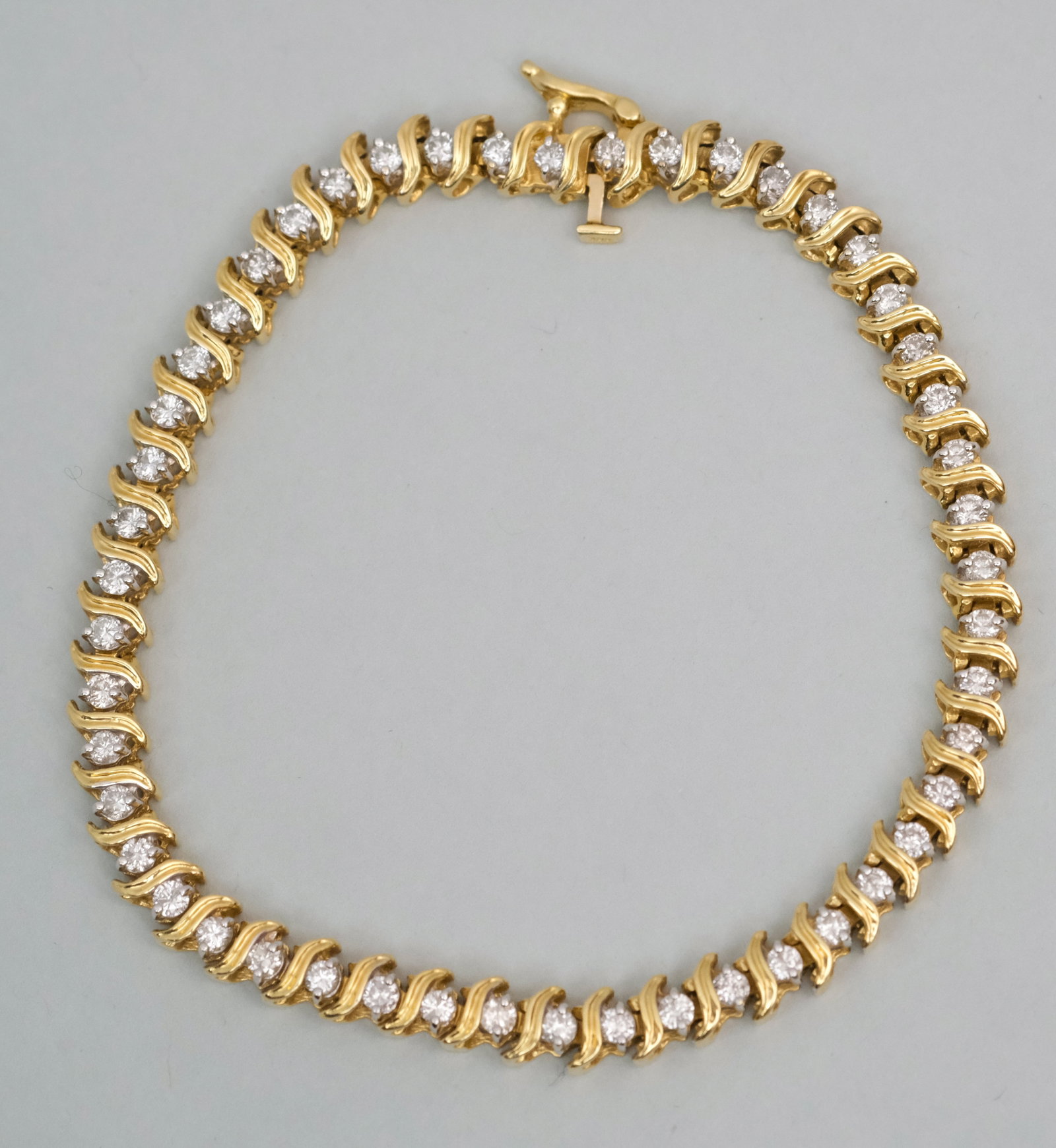 14K Gold & Diamond Tennis Bracelet: Elegant diamond set yellow gold. 7 3/8" end to end. 6.9 dwt.