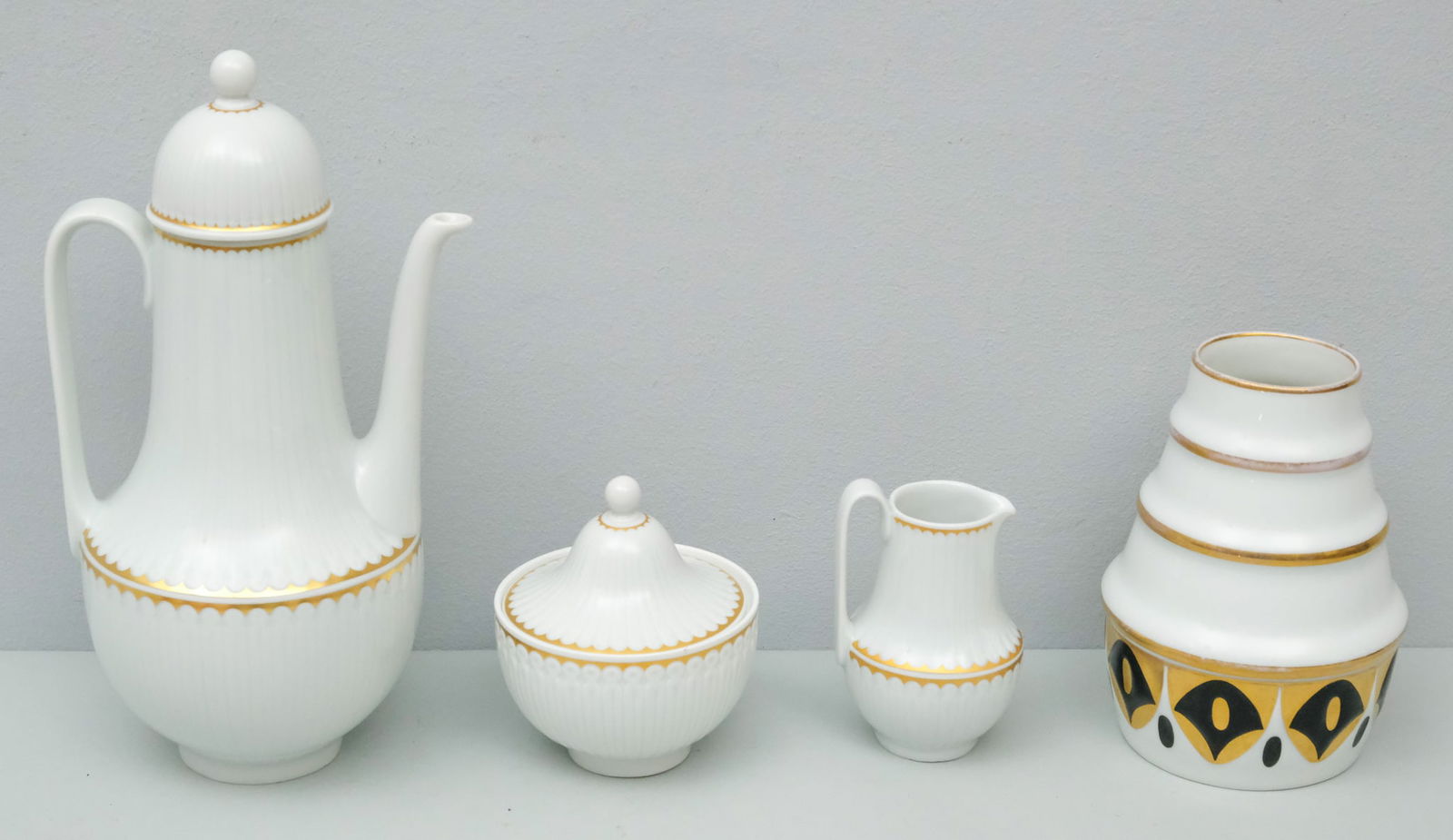 Hutschenreuther Porcelain Demitasse Set: Fluted body with gilt highlights. Marked as shown. Together with a Hutschenreuther vase from Professor Fritz Klee. Teapot 9" high.