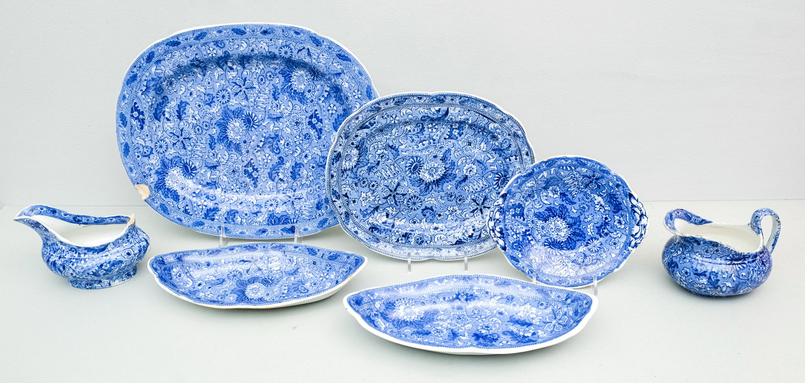 Group of Cauldon Blue Siam Transferware: Comprising a lemon dish, (2) relish dishes, a pair of graduated platters, a creamer, and a saucer boat. Largest platter 13".