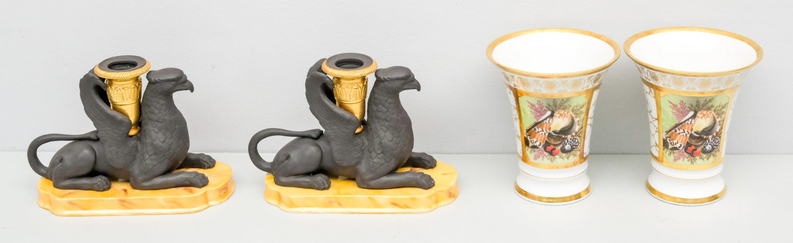 Group of Fine Mottahedeh Porcelain: Comprising a pair of figural gryphon chambersticks and a pair of spill vases. Spill vases 5"
