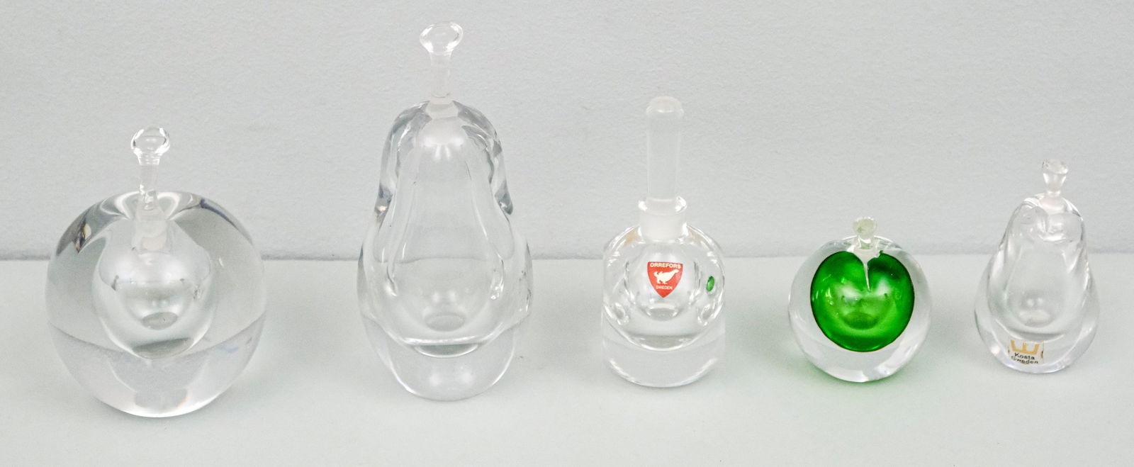 Group of 4 Kosta Art Glass Pear Perfume Bottles: Including a cased green example. Together with an Orrefors perfume. Largest 5 1/4"
