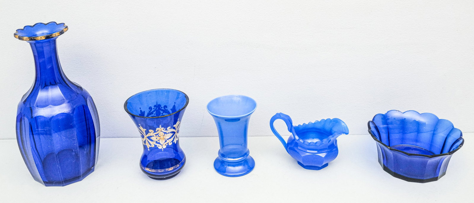 Lot of Antique Bohemian Cobalt Glass: Lot of various 19th century Biedermeier period Bohemian cobalt cut and polished glass forms, largest 10" x 5" x 5", smallest 3 1/2" x 5" x 3".