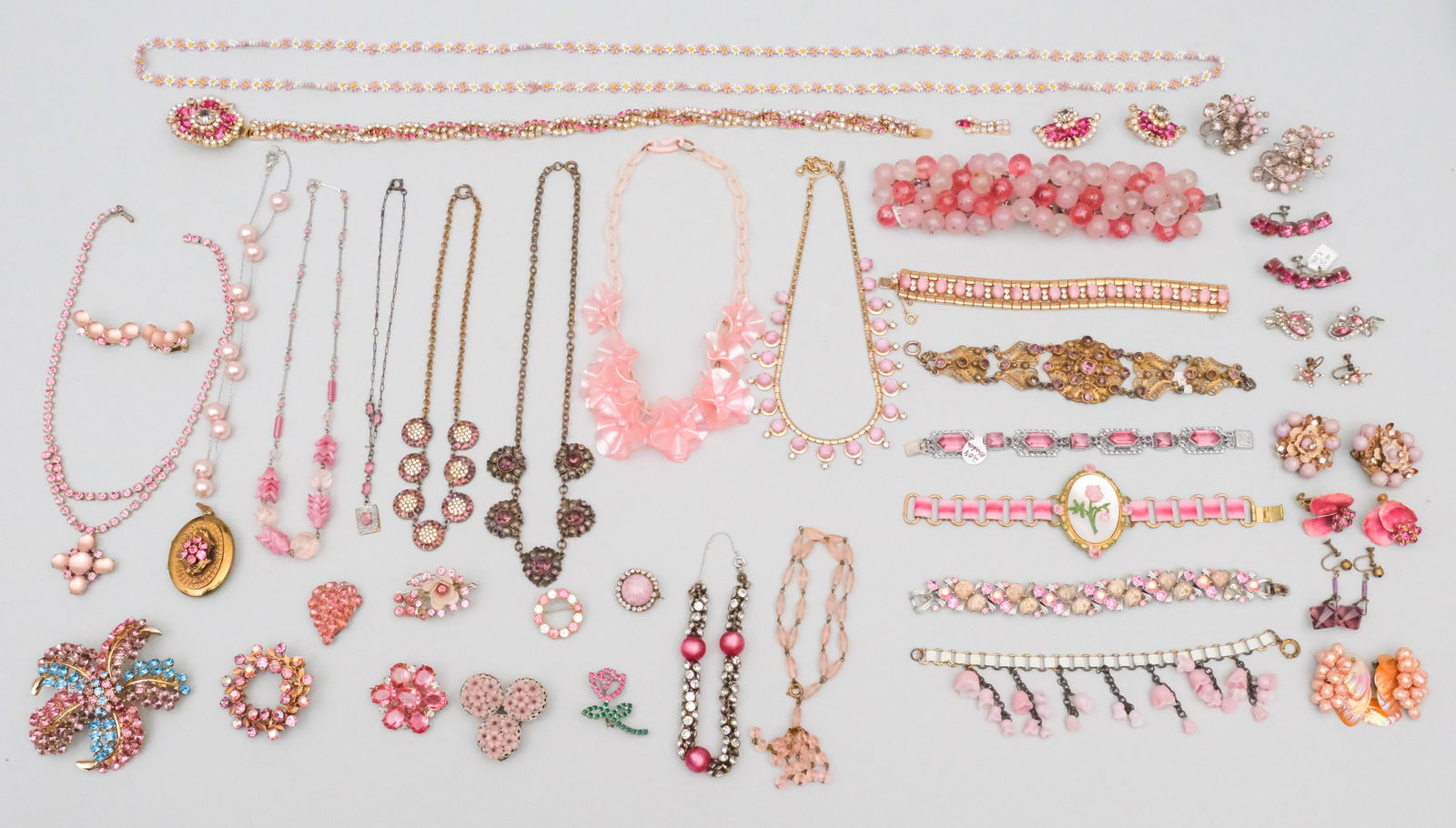 Group of of Pink Toned Costume Jewelry: Wonderful group of antique, vintage and designer costume jewelry that will make you pretty in pink. Including fine crystal, glass work and vintage metal work. Perfect for all your Barbie cosplay needs