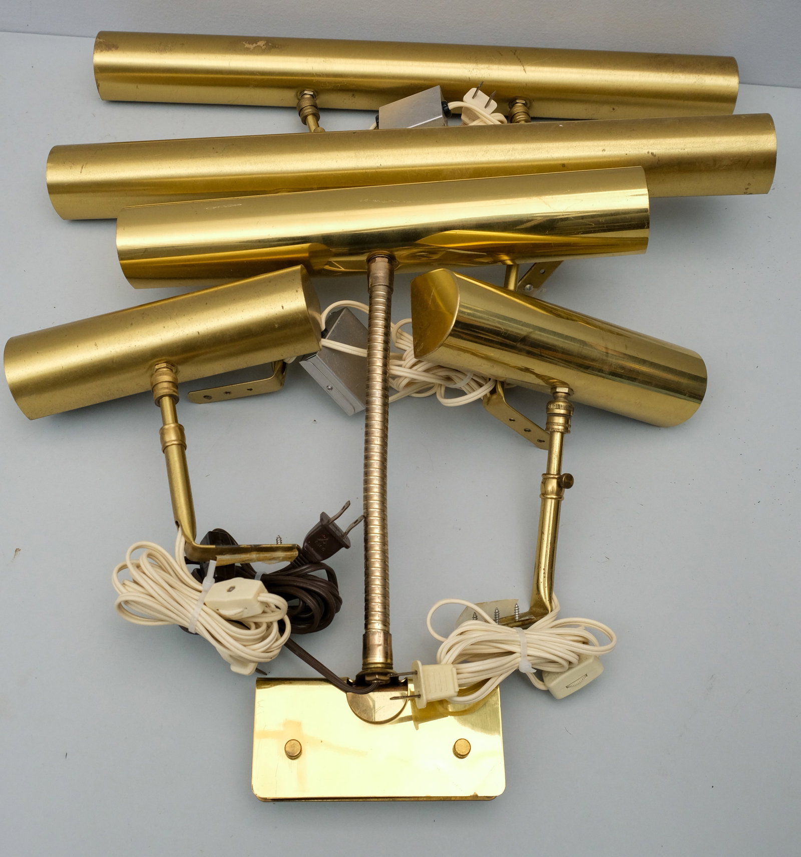 Group of Painting Gallery Lights: Mostly House of Troy. In an antique brass finish. 8" to 21".