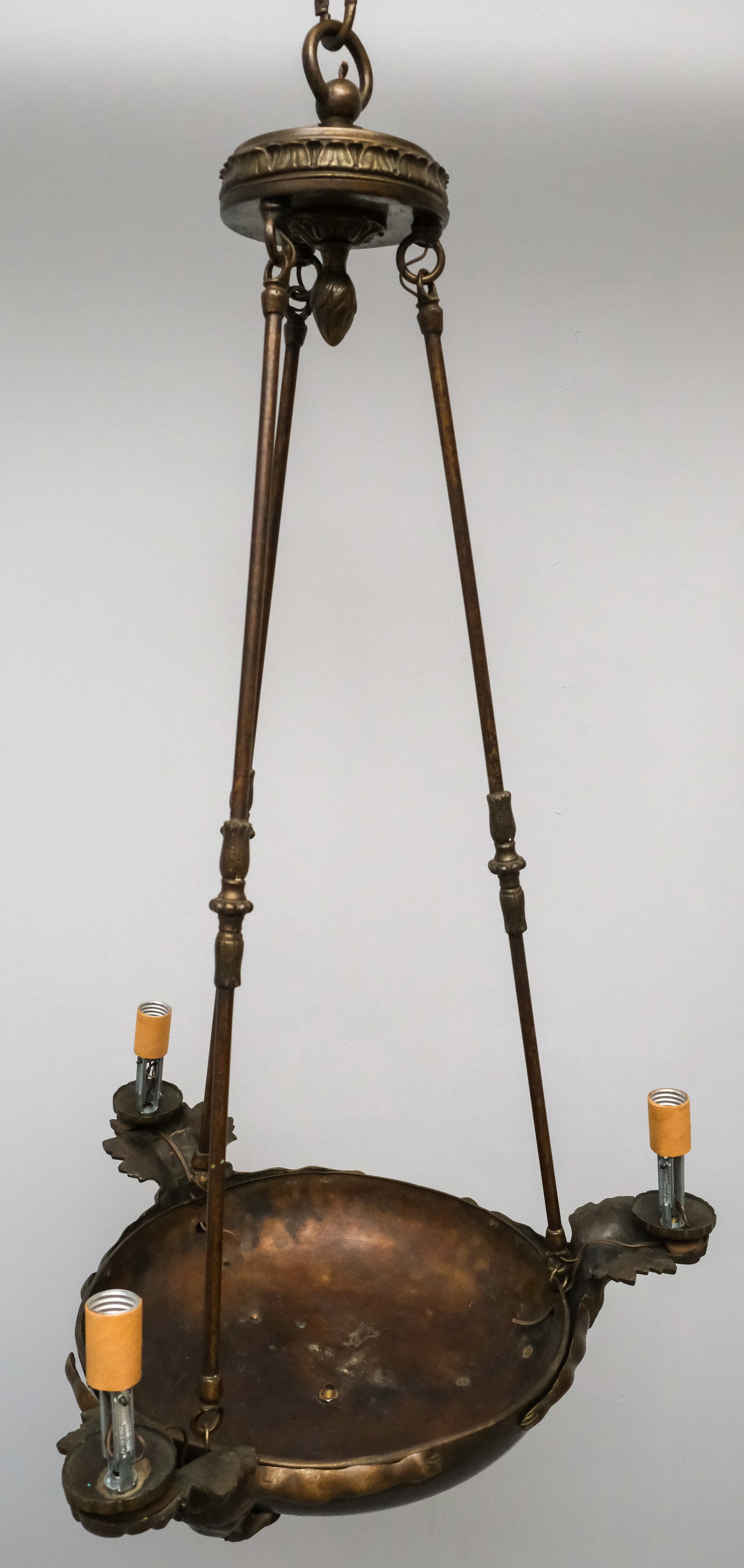 Art Deco Mythological Chandelier: Arts & Crafts / Deco style, 3 suspension rods holding up a large pan, rimmed with 3 male mythical figures with outstretched arms.. Measures 20" X 20" X 45".