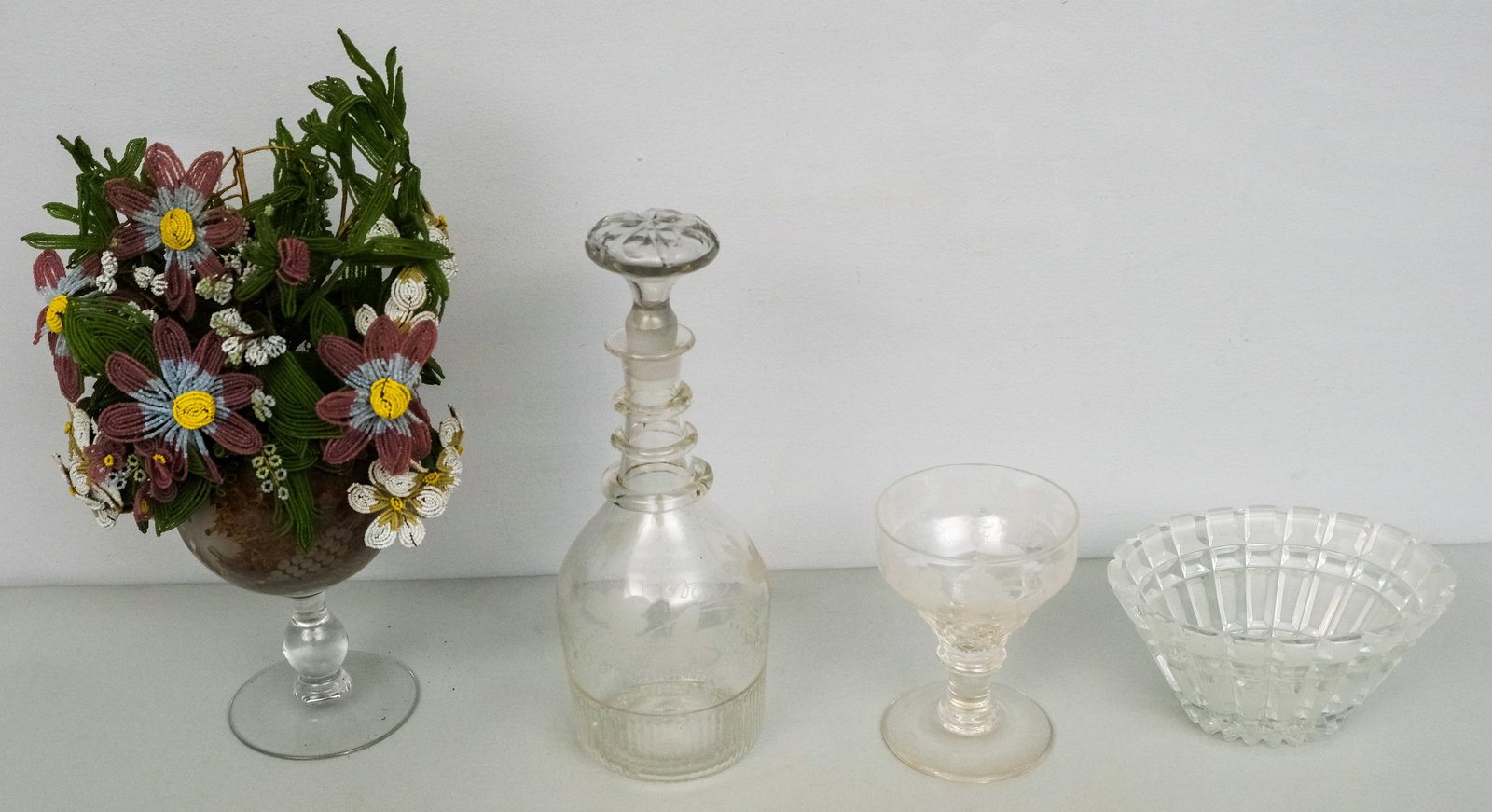 Lot of Antique Glass: Including an Anglo Irish etched decanter with matching goblet and a glass beadwork floral arrangement. Floral arrangement 10" x 15".