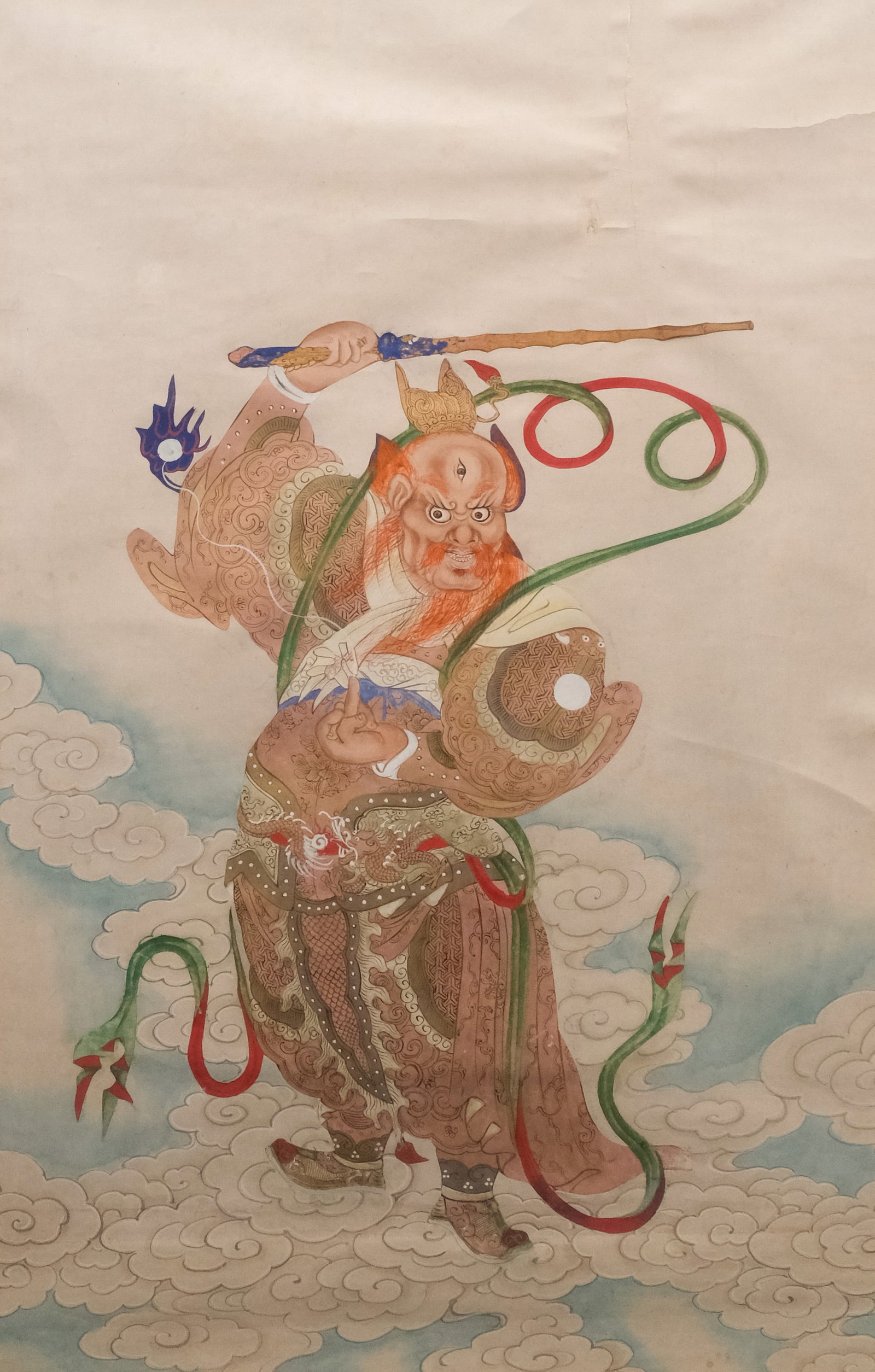 Chinese School, Taoist Deity: Chinese, early 20th century gouache on paper depicting a red-haired Taoist deity with a third eye, possibly Erlang Shen, standing among the clouds, 25 3/4" x 17" sight size, 37" x 27 3/4" framed.