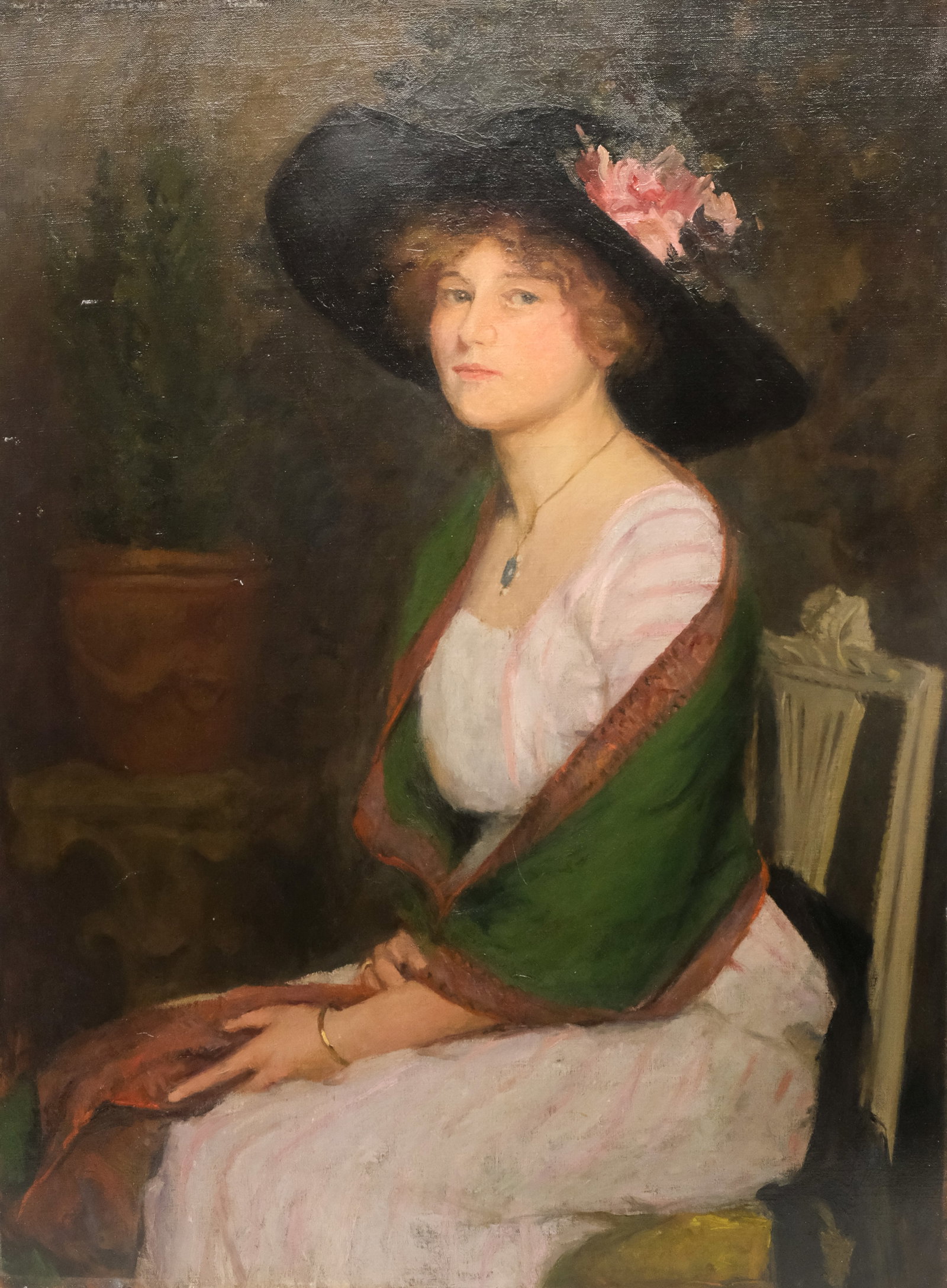 American School, Portrait of a Lady in Pink: American, early 20th century depicting an elegant young lady in a large black hat, wrapped in a green shawl, with partial label verso, 40" x 30" canvas.