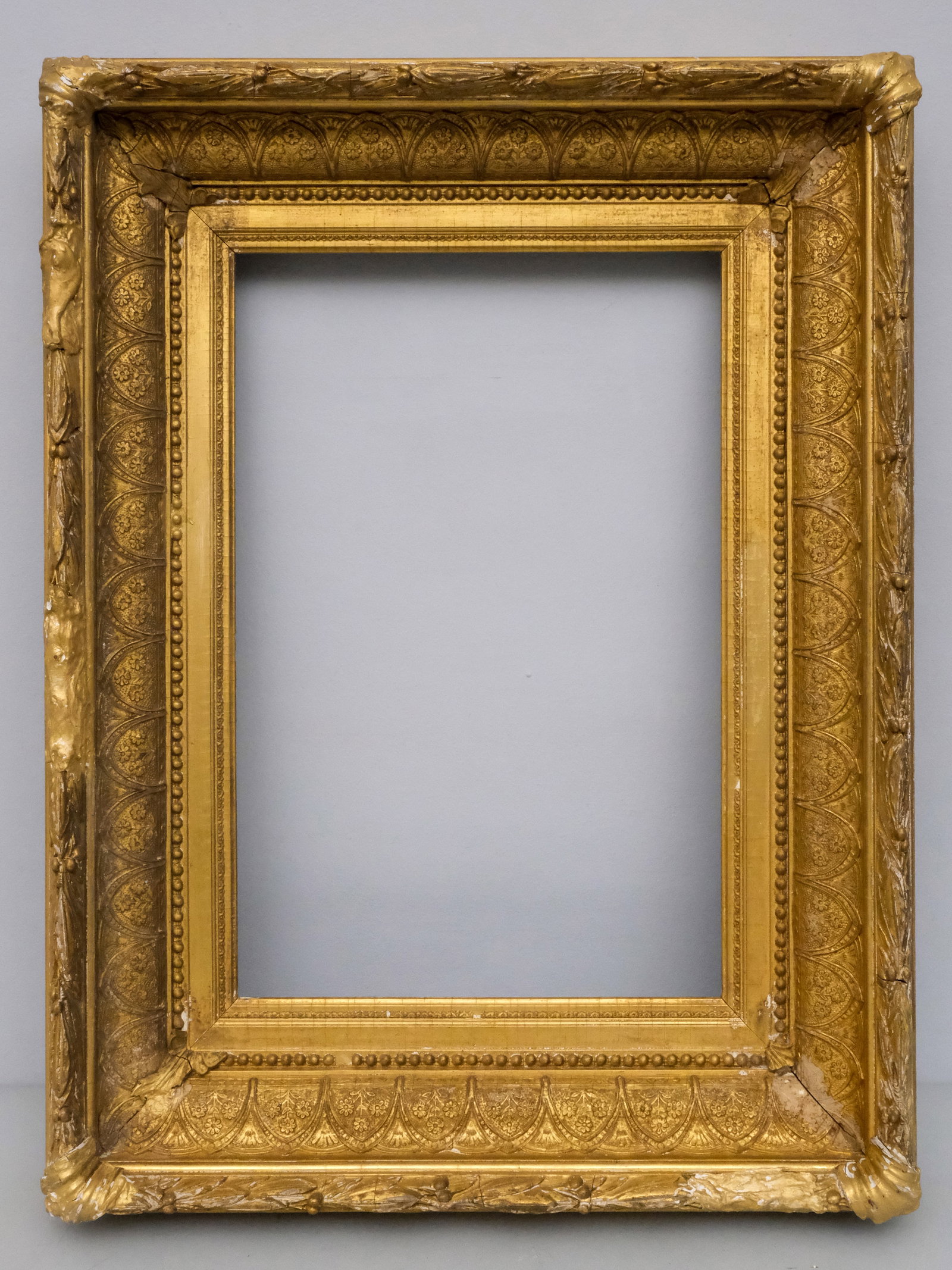 American Hudson River School Frame 12" x 18": American, circa 1870, having laurel and berry top edge and foliate ogee profile. Overall 20 1/2" x 26 1/4", rabbet 12" x 18", molding 4 1/2".