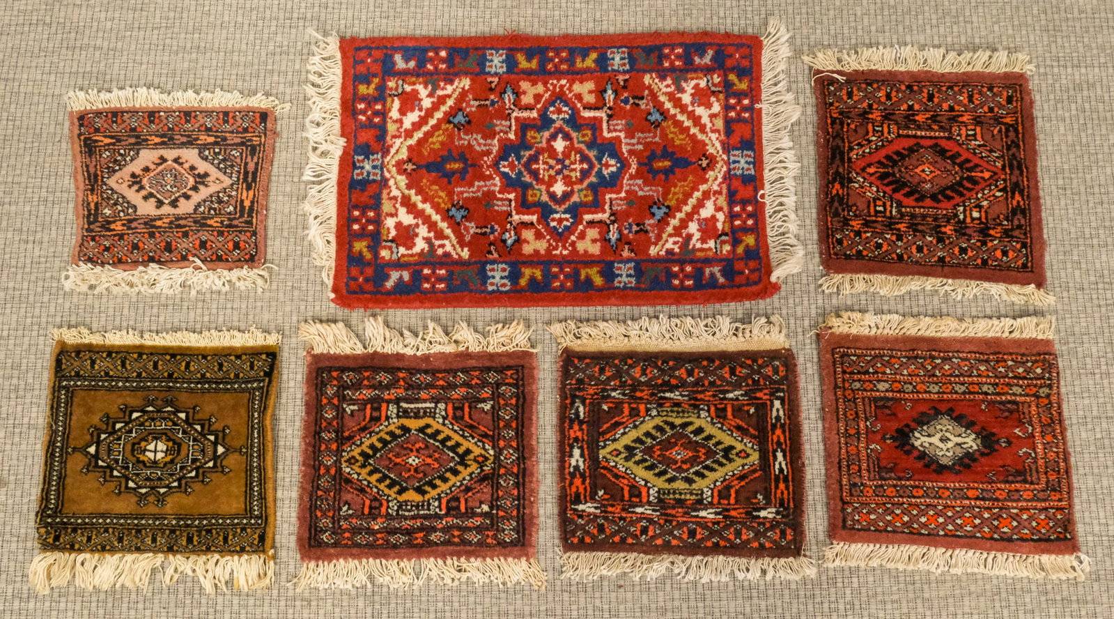 Group of Seven Small Prayer Rugs: 20th century, lot of 7 tribal rugs, largest: 16" x 27"