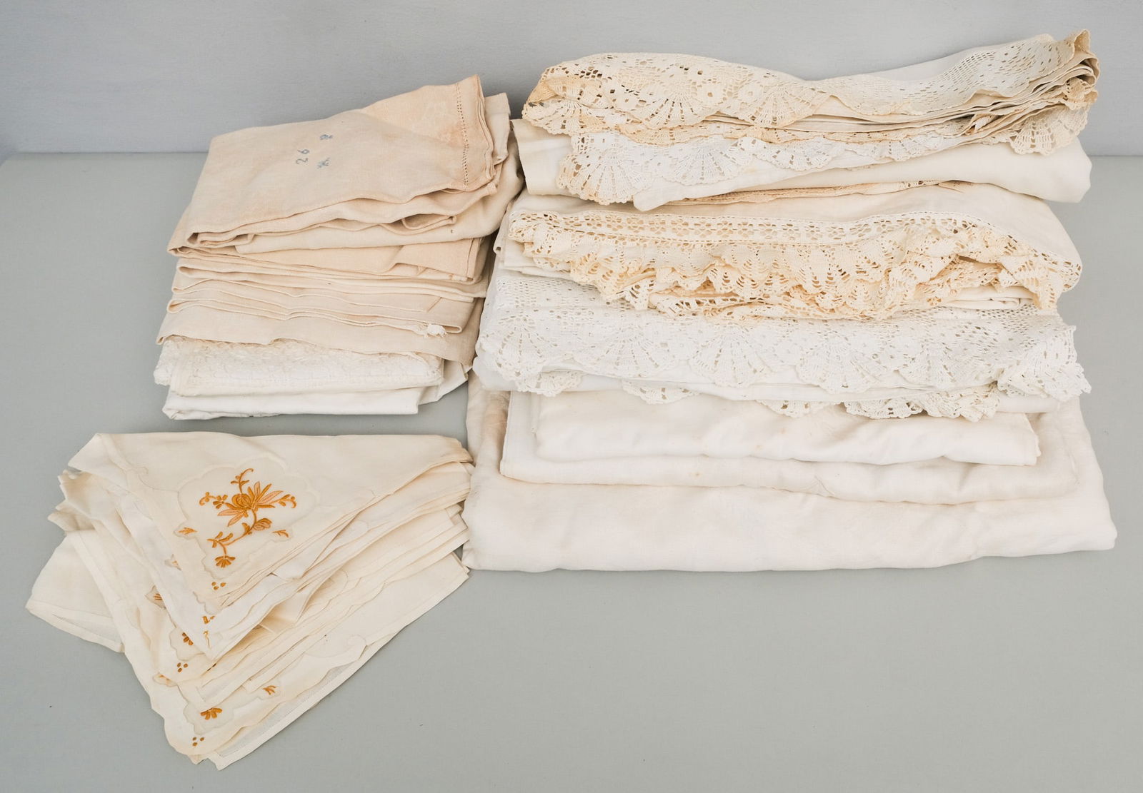 Lot of White Linens & Tablecloths: Lot of vintage white linens, tablecloths, and napkins, some with lace, some embroidered, and more.