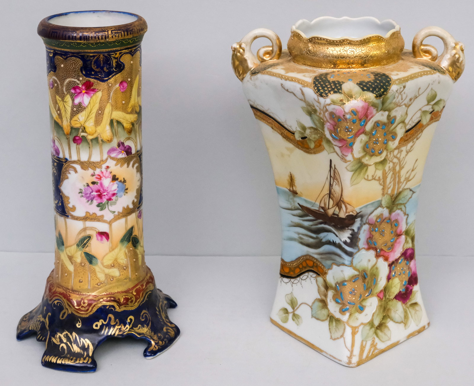 Two Antique Nippon Porcelain Vases: Comprising a Morimura square bodied vase with bejeweled Moriage and a heavily decorated example with blue character mark. 11 1/4" and 11 3/4".