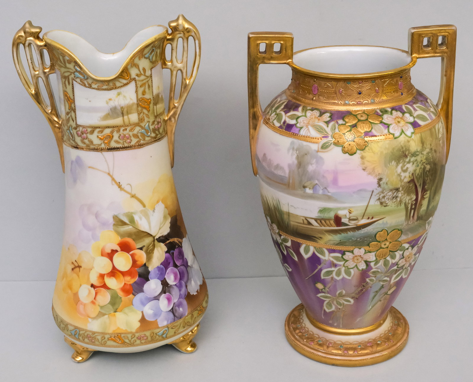 Two Antique Nippon Porcelain Vases: Comprising a Morimura vase with finely reticulated handles and grape decoration, and a heavily bejeweled and gilded Moriage vase with landscape decor, also by Morimura. 13" and 13 3/4".