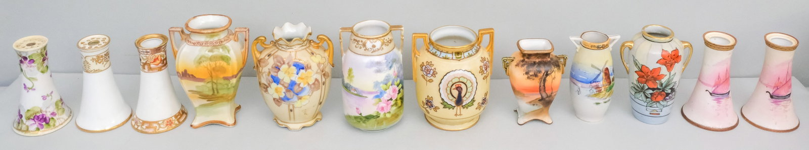 Collection of Small Antique Nippon Porcelain Vases: Various forms, together with two hat pin holders. Tallest 5 3/4.