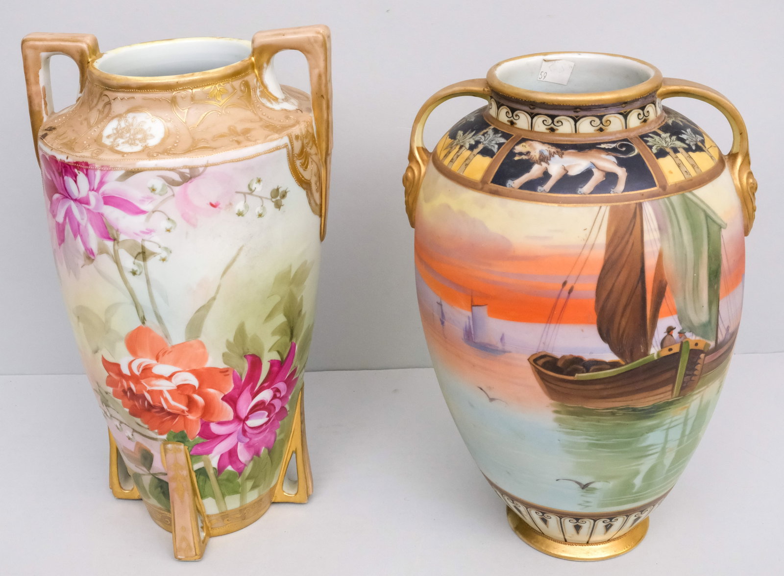 Two Antique Nippon Porcelain Vases: Comprising a Morimura Gumi vase with applied feet and angular handles (small chip restoration to one foot), together with a Morimura example with embossed handles and Venetian scene. 12" and 12 3/4".