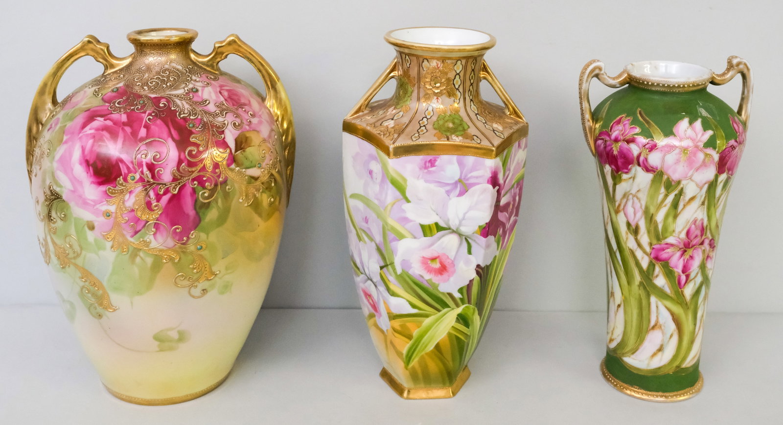 Three Antique Porcelain Nippon Vases: Comprising a large Morimura Gumi vase with Moriage and roses, a hexagonal bodied Morimura vase, and a green field Nippon vase with floral decor. 11 1/2" to 13".