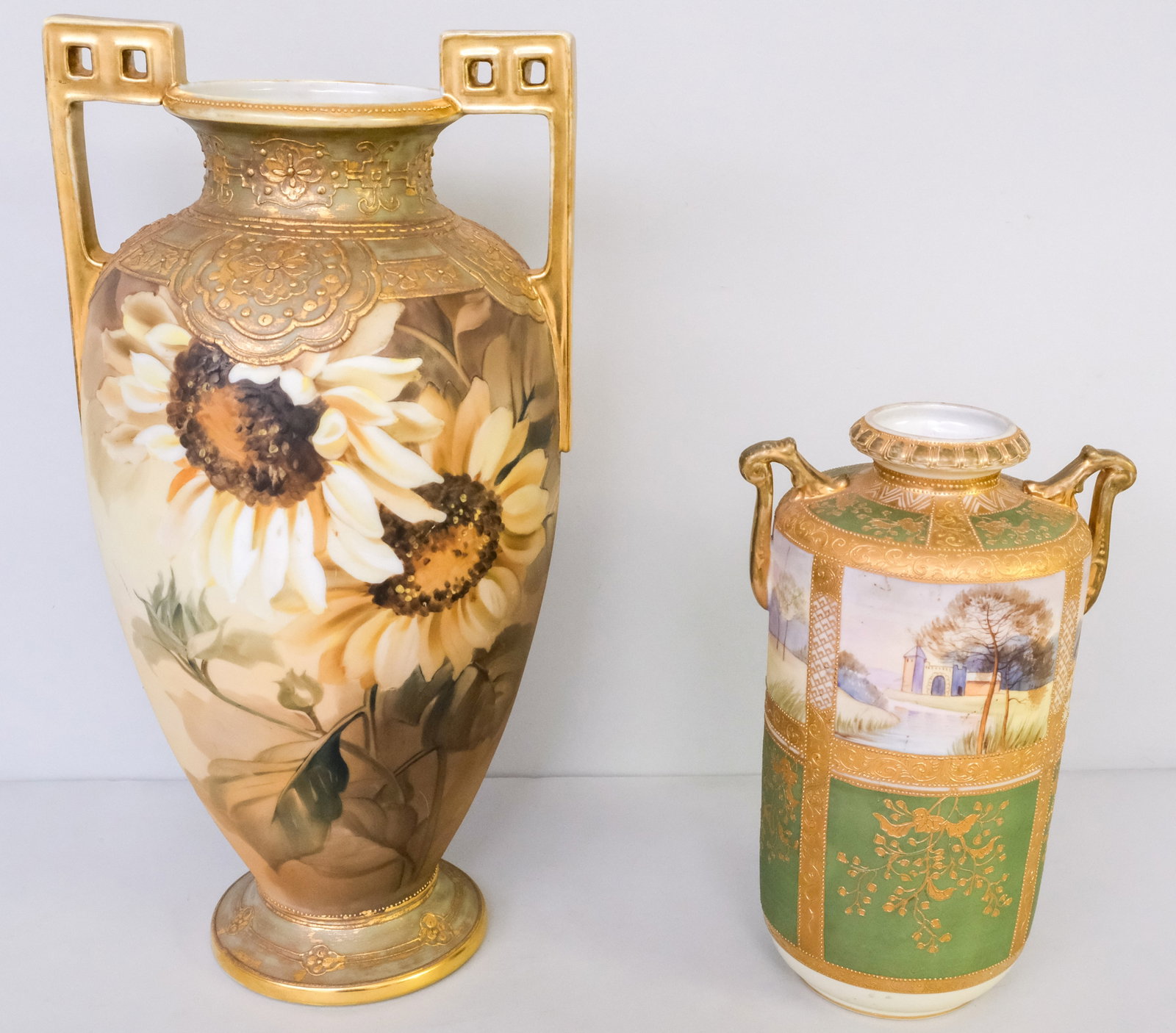 Two Antique Nippon Porcelain Vases: Comprising a heavily gilded Morimura vase with landscape cartouche and green field, and an immense Morimura vase with orientalist Moriage. 11" to 16 3/4".