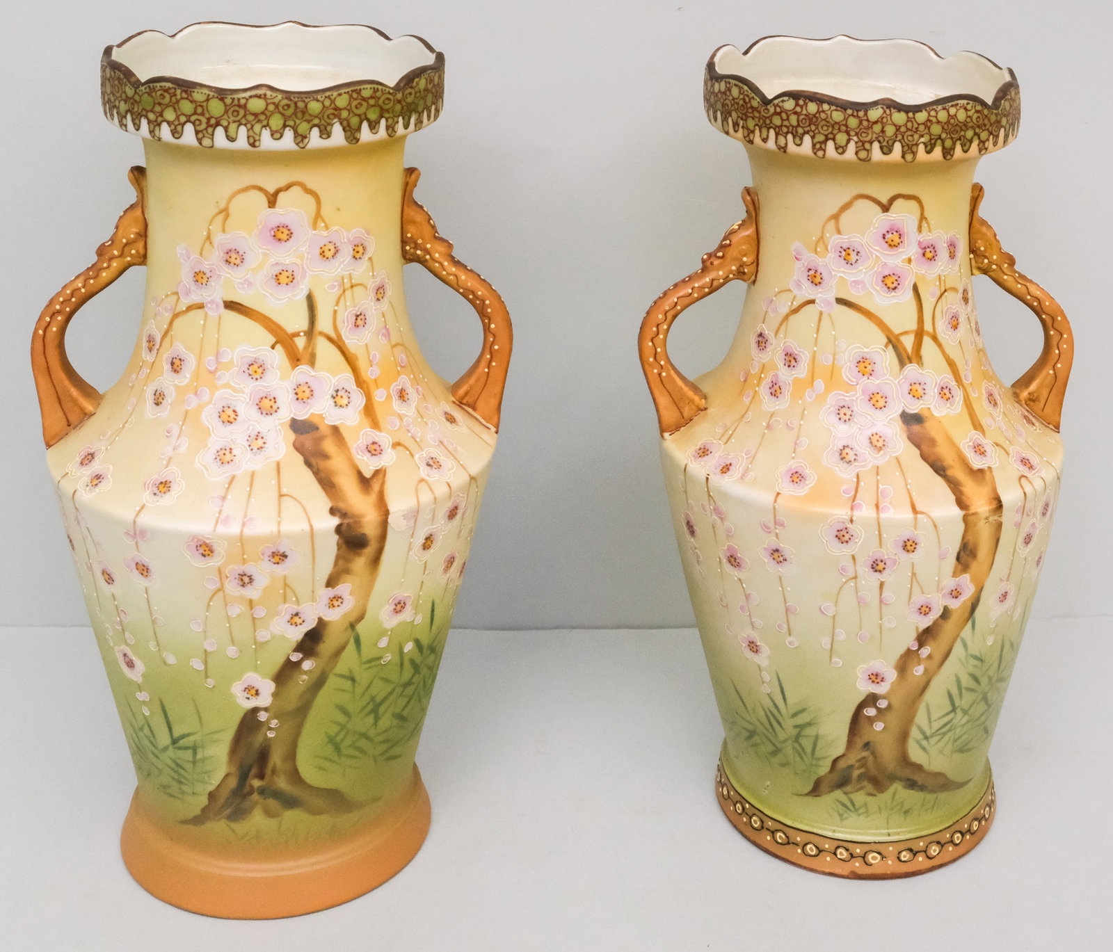 Near Pair of Antique Nippon Porcelain Vases: Decorated with Moriage cherry blossoms and branch handles. 12".