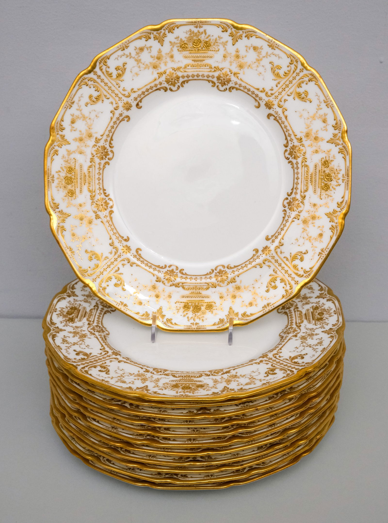 Set 12 Royal Doulton for Tiffany Porcelain Plates: Twelve dinner plates with heavy gold encrustation and floral decor. 10 3/8".