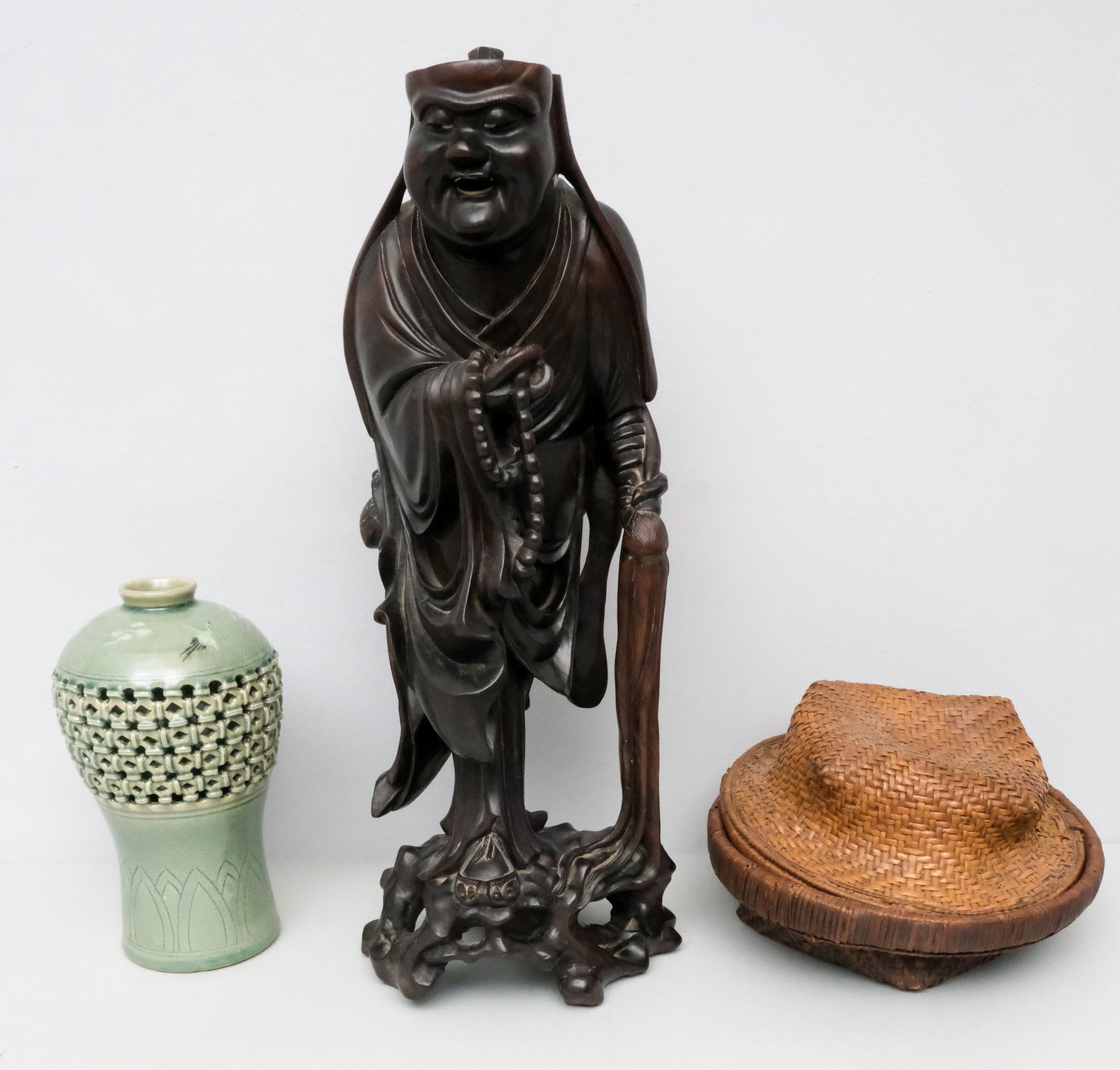 Group of Asian Antiques: Comprising a carved box wood figure of a monk, a celadon vase, and a woven basket. Monk 19 1/2".