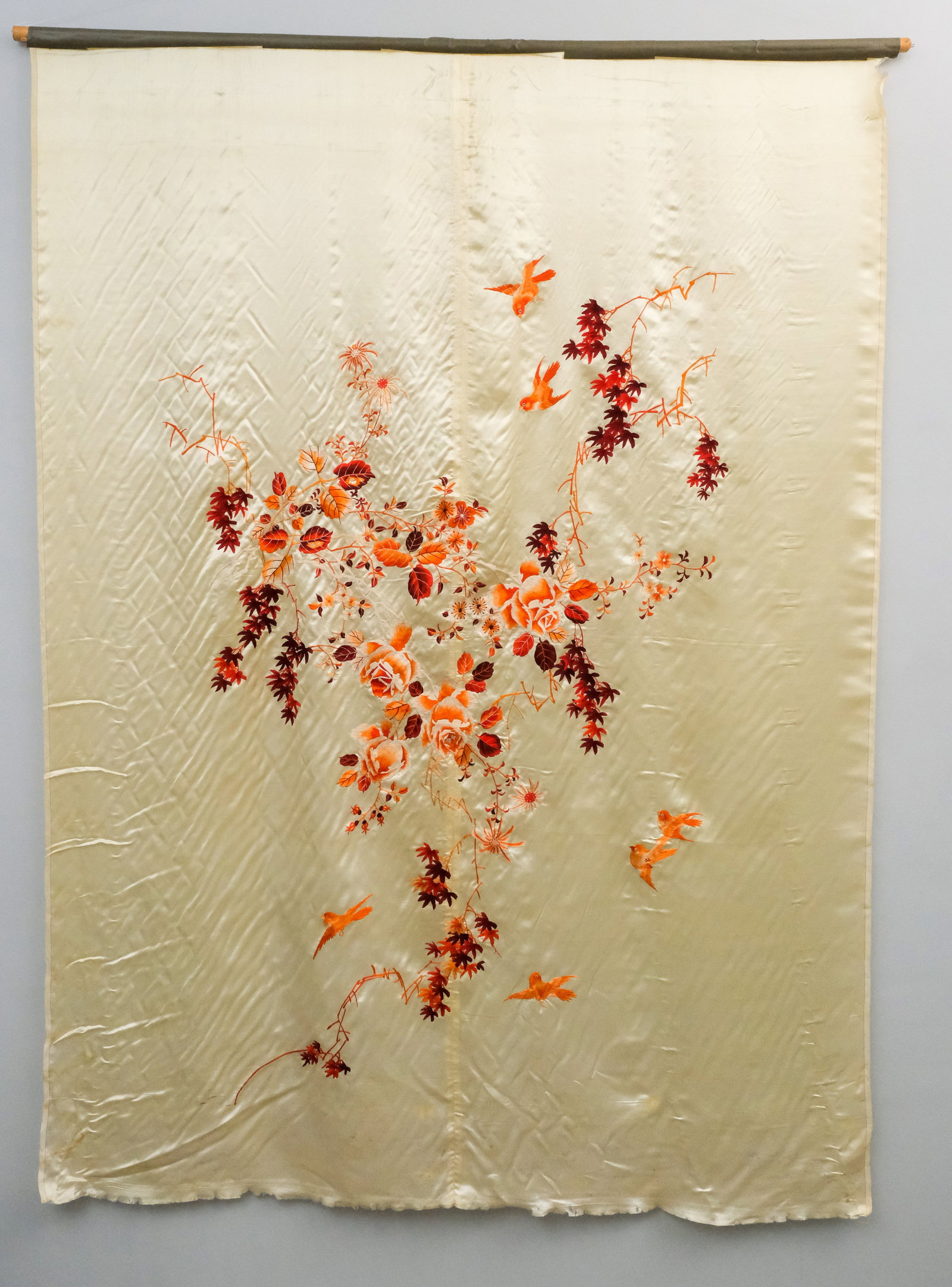 Asian Silk Hanging Embroidery: Asian, early 20th century red and pink embroidered cream colored silk, depicting birds on flowering branches, 78" x 55 1/2".