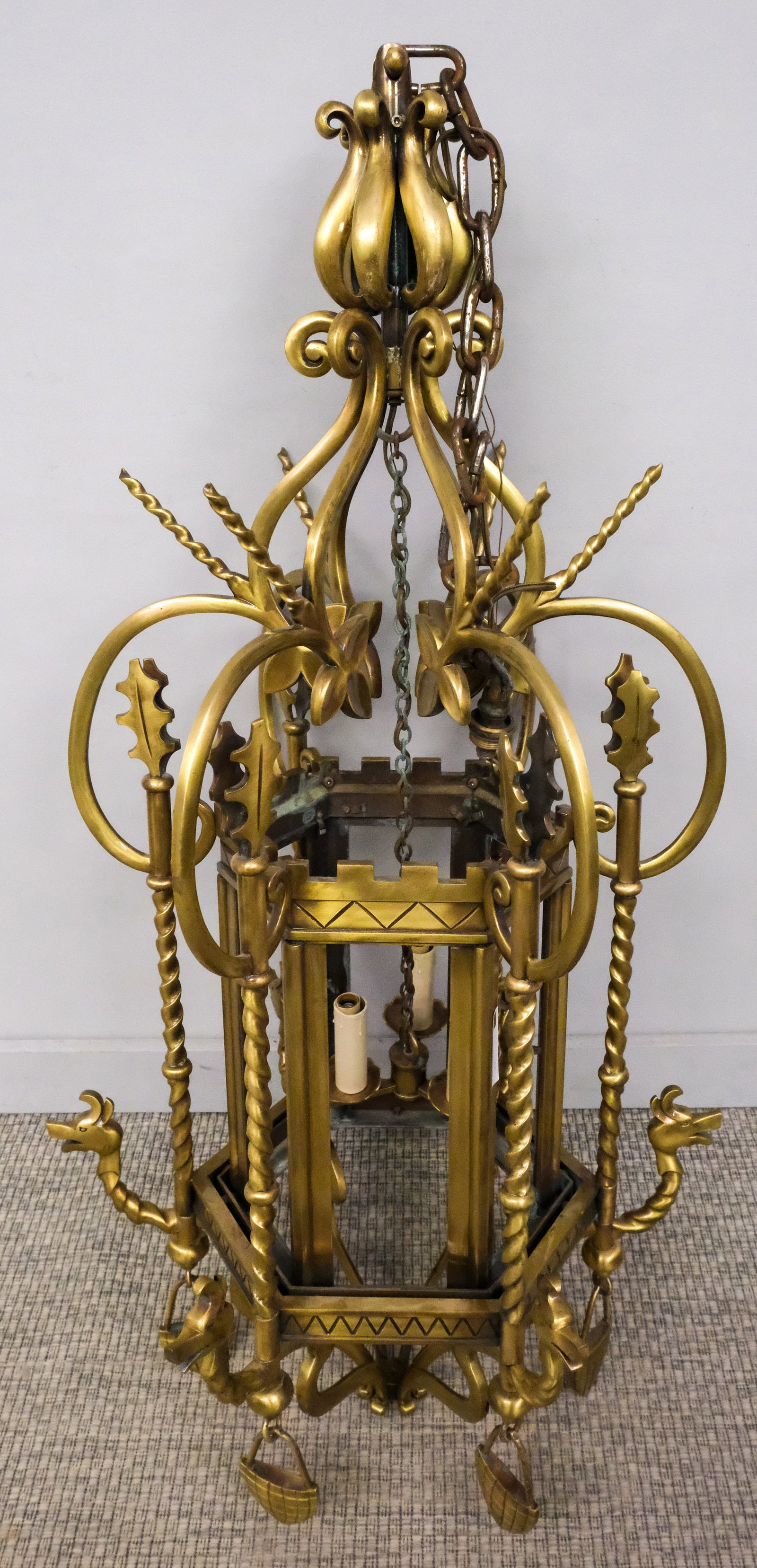 Custom Patinated Bronze Hexagonal Lantern: Custom patinated bronze hexagonal hanging lantern designed by Les Metalliers Champenois and fabricated by Smith Architectural Group, decorated with dragons' heads, horns and barley twists, 48" H x 21