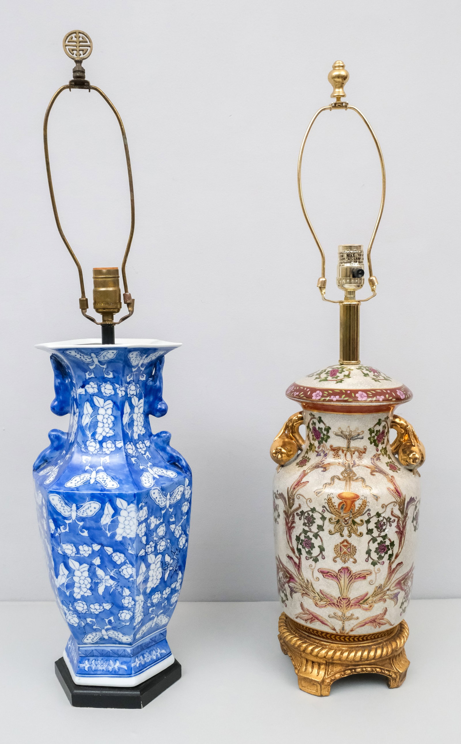 Two Chinese Porcelain Lamps: Comprising a blue & white lamp with butterflies and a French palace style lamp with golden fruit handles. 31" and 31 1/2".