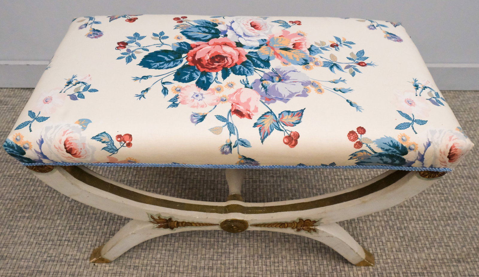 Neo-Classical Curule Bench: 20th century Neo-Classical style curule bench with white and floral upholstery, 19" H x 30" W x 16" L.