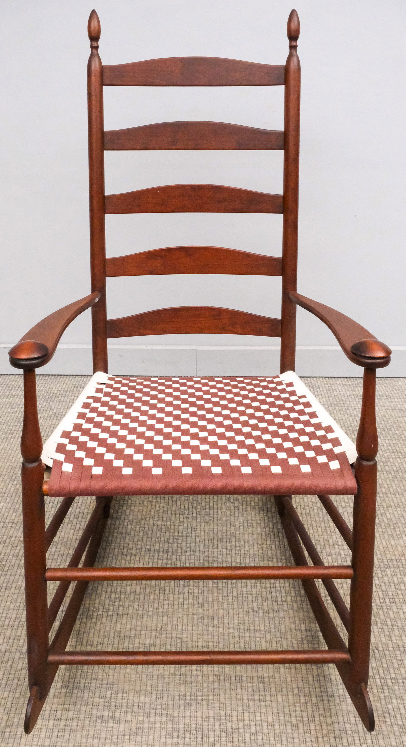 Shaker Rocking Chair: 20th century Shaker rocking chair with woven seat, ladder back with pointed finials, originally purchased from The Shaker Shoppe in Lititz, PA, 47" H x 30" W x 24" L.
