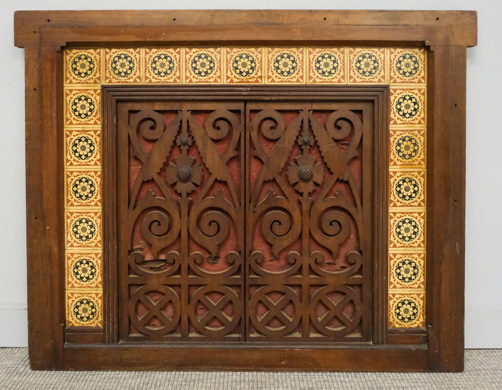 Eastlake Architectural Fireplace Cover: 19th century architectural fireplace cover with carved wooden central panel, lined with likely Minton tiles, 35 1/2" x 45".