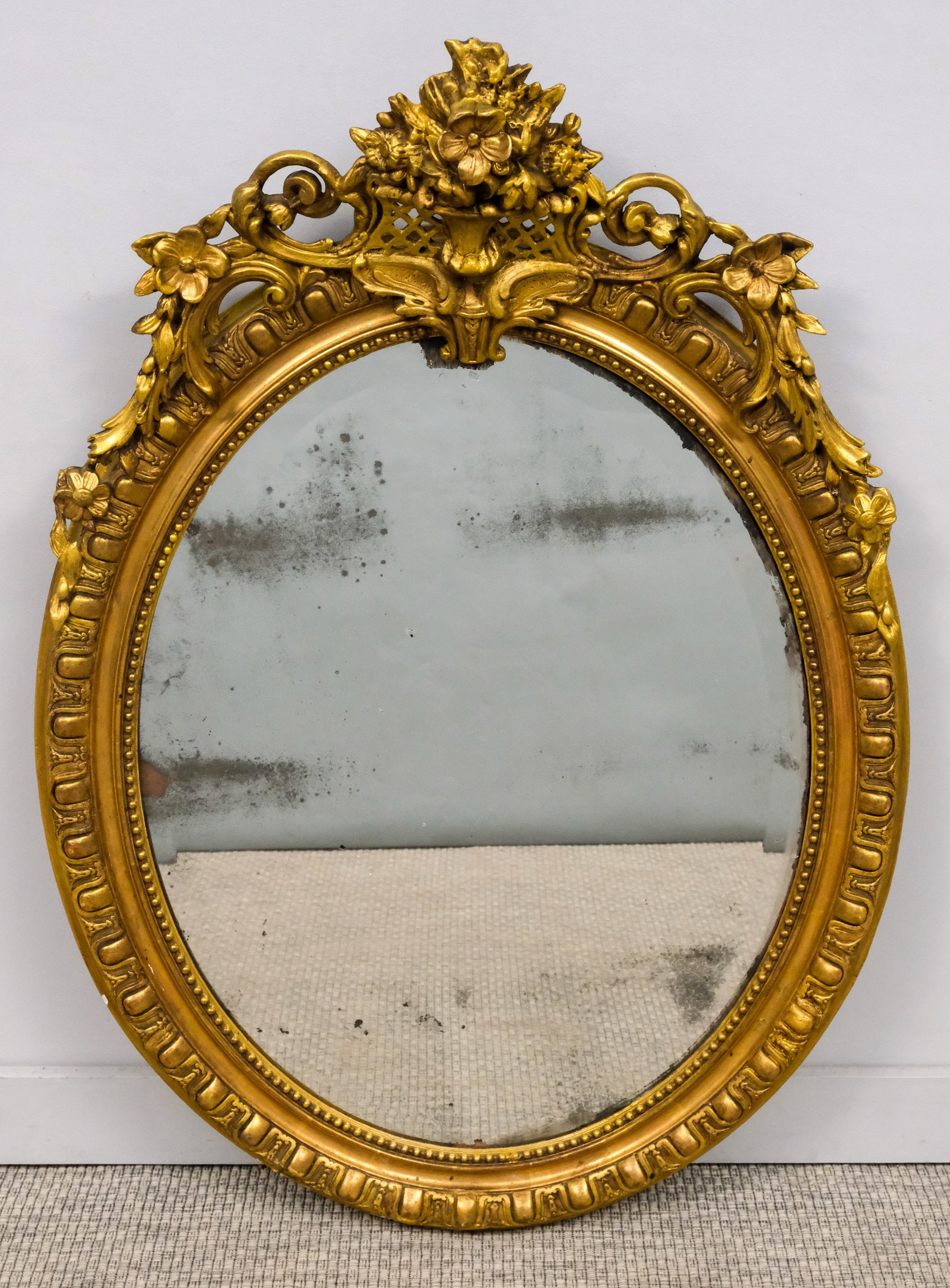 Antique French Louis XVI Mirror: 19th century French Louis XVI style giltwood oval mirror, with beveled glass, 46" x 32".