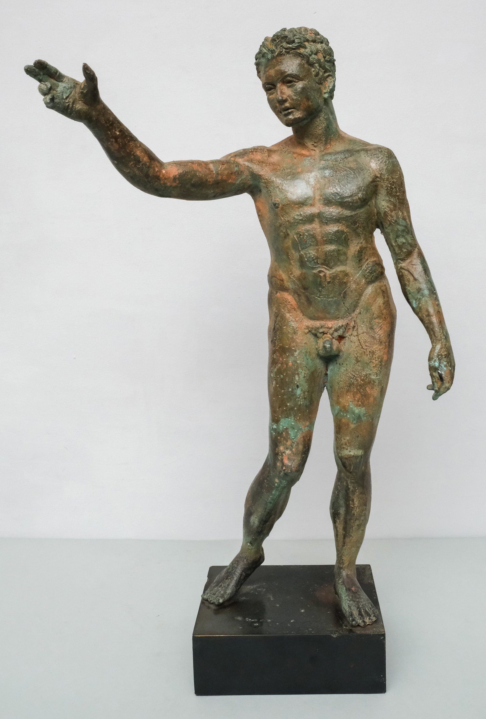 Neoclassical Style Bronze Statue: A nude man with outstretched arm. patinated surface and custom base. 25 1/4".
