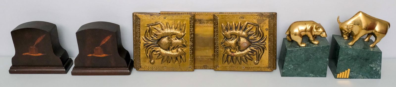 Group of Antique & Vintage Bookends: Comprising a pressed brass adjustable, a pair of inlaid wood examples, and a Bull & Bear pair in brass on green marble.