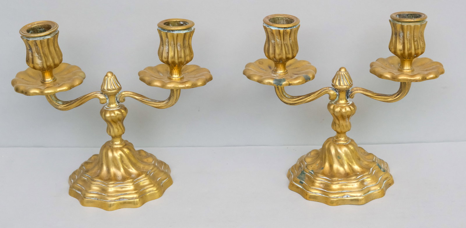 Pair of Antique Bronze 2-Socket Candelabra: Swirled body with twisted arms and sockets. 6 1/2" x 7 1/2".