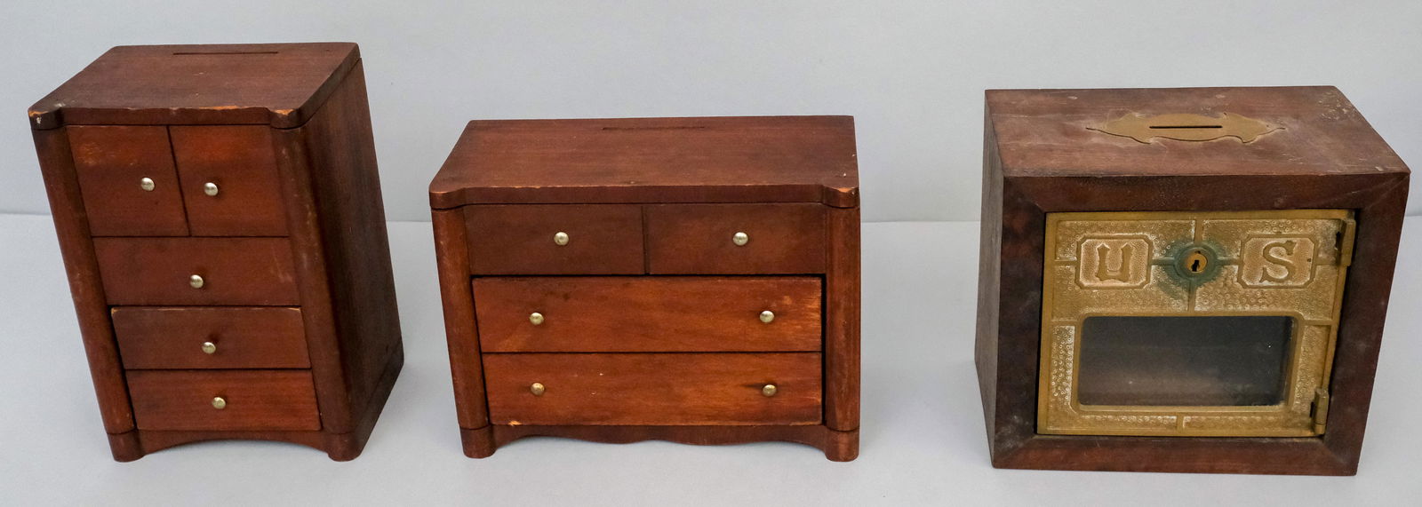 Group of 3 Antique Banks: Comprising two chest of drawer form banks and a post office bank. Tallest 8 1/4".